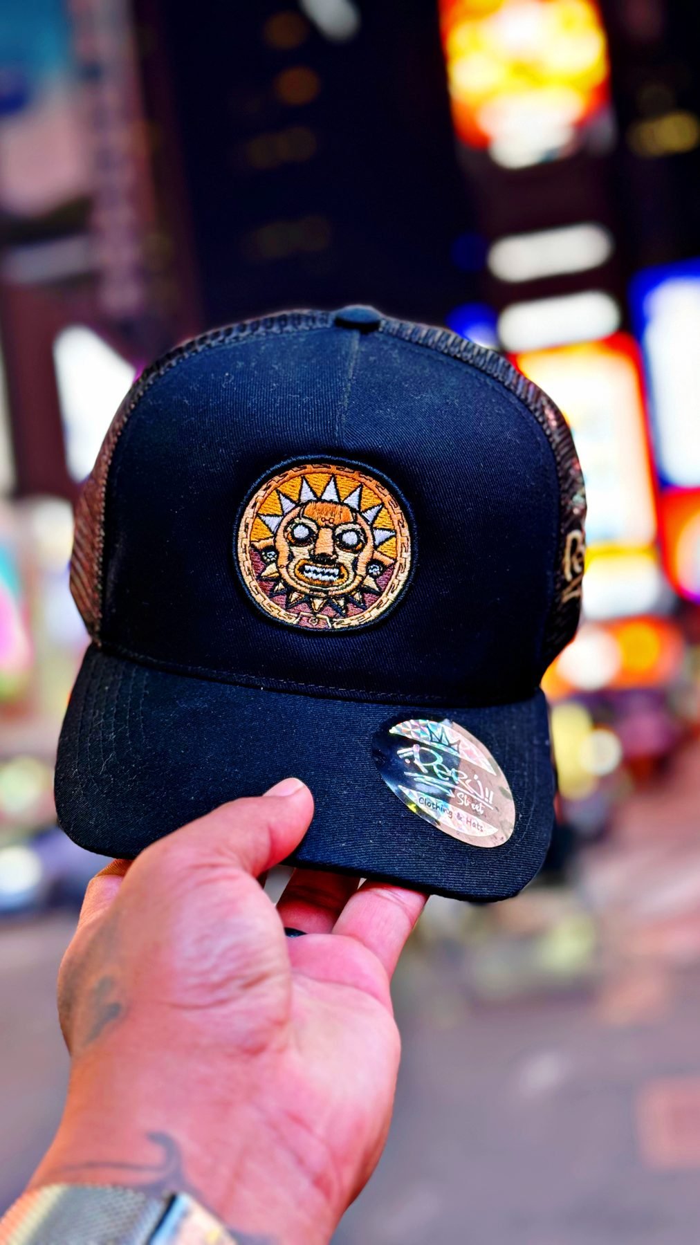 Peru Street Inti trucker cap held up in Times Square, New York