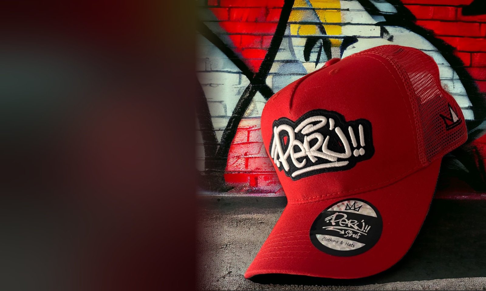 Red Peru Street trucker cap against a graffiti wall